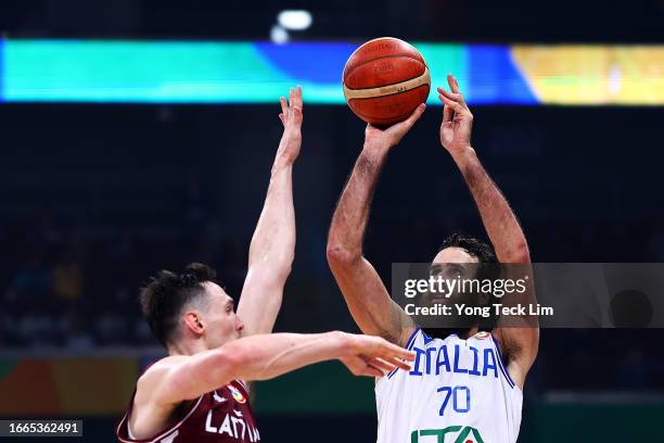 Luigi Datome of Italy attempts a three-pointer against Rodions Kurucs of Latvia in the fourth quarter during the FIBA Basketball World Cup...