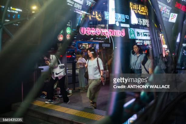 Commuters enter the Gangnam metro underground train station in Seoul on September 14, 2023. Seoul's Gangnam district, which was made famous by rapper...