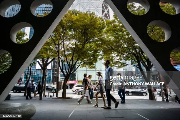 Pedestrians walk along a street in the Gangnam district of Seoul on September 14, 2023. Seoul's Gangnam district, which was made famous by rapper...