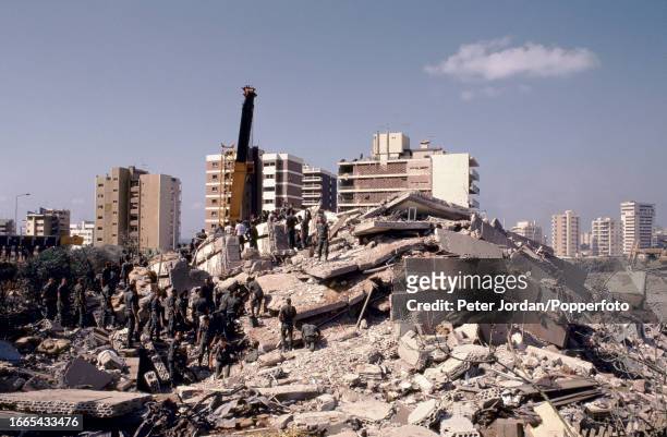 Crane assists rescuers search for survivors of a terrorist truck bomb attack on the barracks building housing servicemen from the 2nd Marine Division...