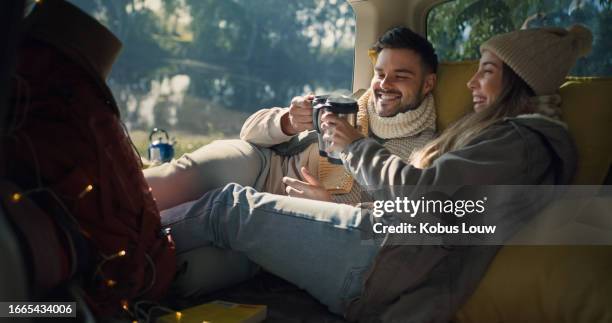 van, coffee cheers and happy couple camping, bonding and relax together for vacation tour, love connection or nature freedom. fun camper, tea cup and romantic people fun at car, caravan or campsite - winter relaxation stock pictures, royalty-free photos & images