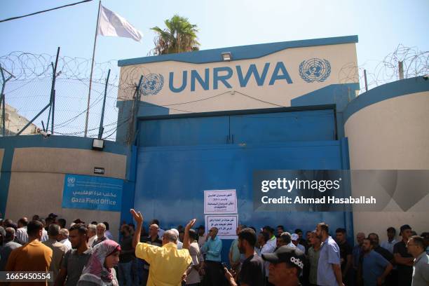 Home-owners whose properties were destroyed during the 2014 war between Israel against Hamas and other Palestinian factions demonstrate outside the...