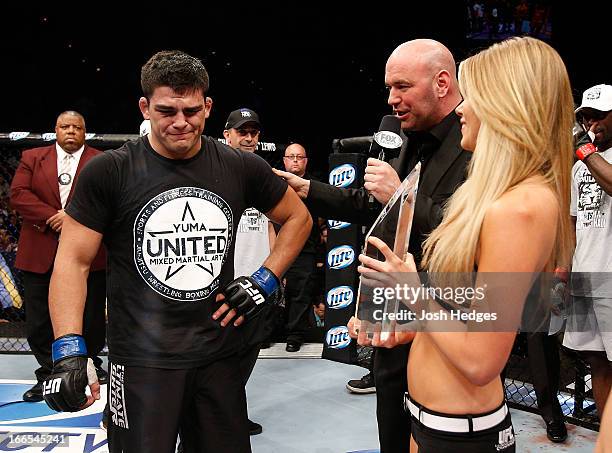 Kelvin Gastelum is presented the Ultimate Fighter season 17 trophy by UFC President Dana White in their middleweight fight at the Mandalay Bay Events...