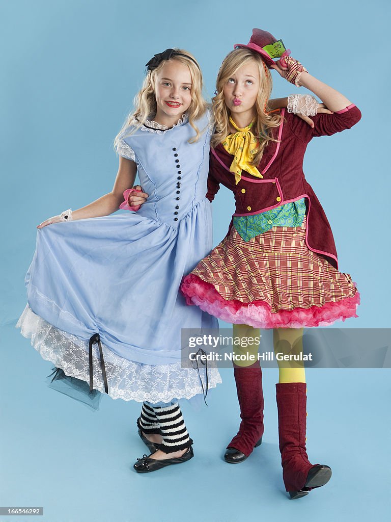 Two girls (10-11) in Alice in Wonderland costumes for Halloween
