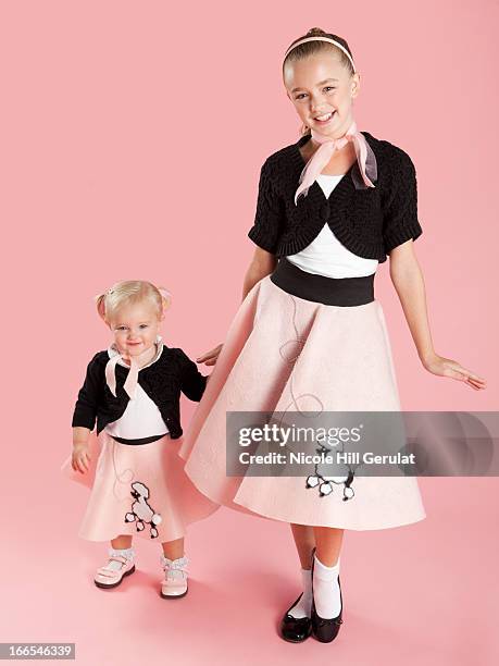 portrait of girls (12-17 months) and (10-11) in 1950s style costumes for halloween - caucasian 11 12 girl portrait vertical beautiful foto e immagini stock