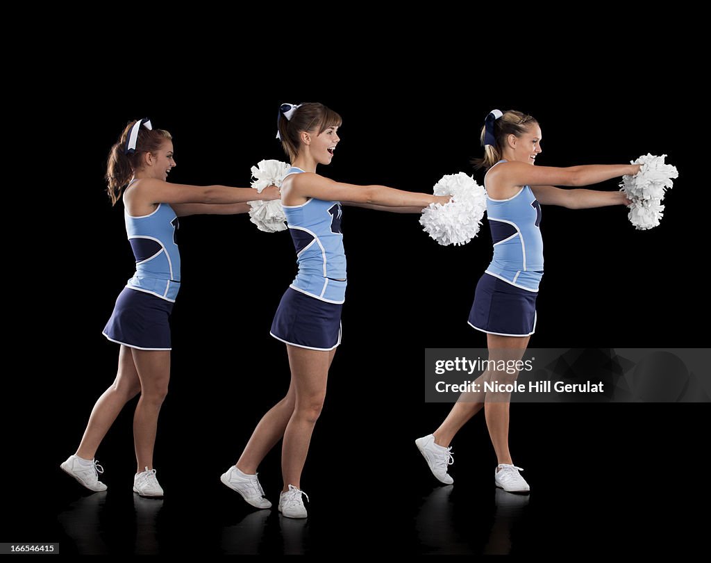 Studio shot of cheerleaders (16-17) dancing