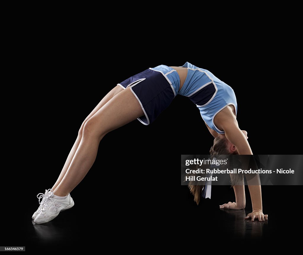Back Hand Spring Cheer Studio Shot Of Cheerleader Performing Back Handspring High-Res Stock ...
