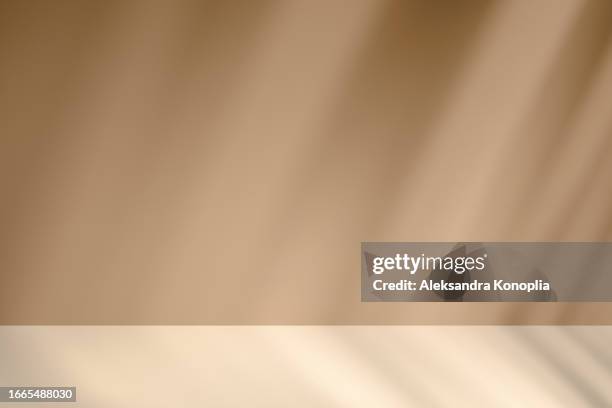 empty studio 3d exhibition background - pastel creamy beige stage with soft natural abstract diagonal window light and shadows. - stage light 3d stock pictures, royalty-free photos & images