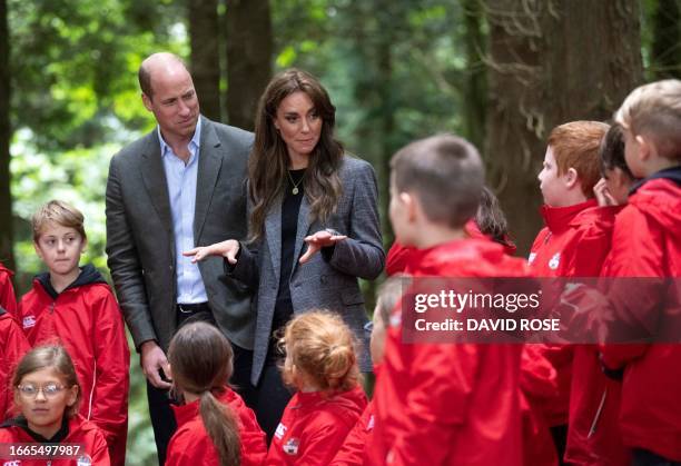 Britain's Prince William, Prince of Wales and Britain's Catherine, Princess of Wales visit Madley Primary School's 'Forest School' in Hereford,...