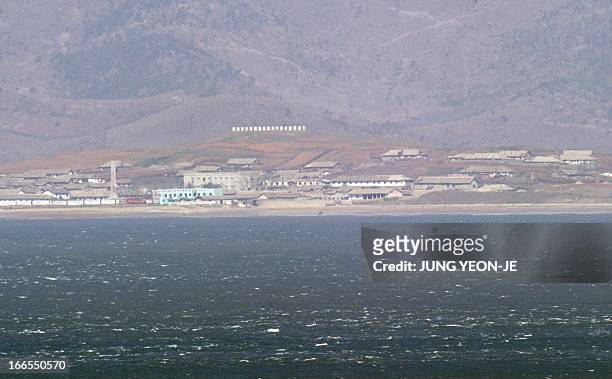 The seafront of North Korea's west coast with signs reading "Long live Great leader Kim Il-Sung and his revolutionary ideology!", is seen from the...