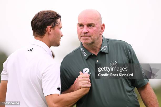 Rasmus Hojgaard of Denmark and Thomas Bjorn of Denmark shake hands on the ninth green during Day One of the Horizon Irish Open at The K Club on...