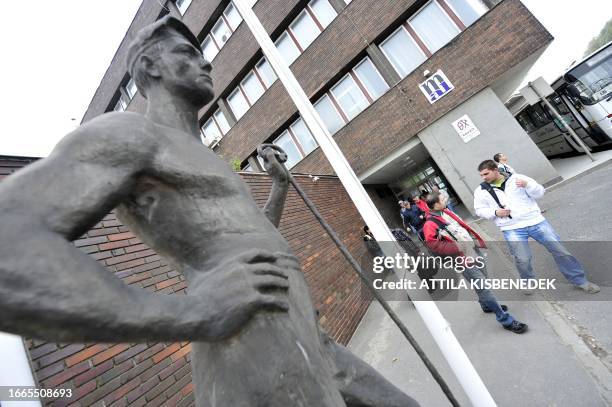 Local workers leave the headquarters of the Hungarian Aluminium Production and Trade Company , about 150 kms south-west from the Hungarian capital...