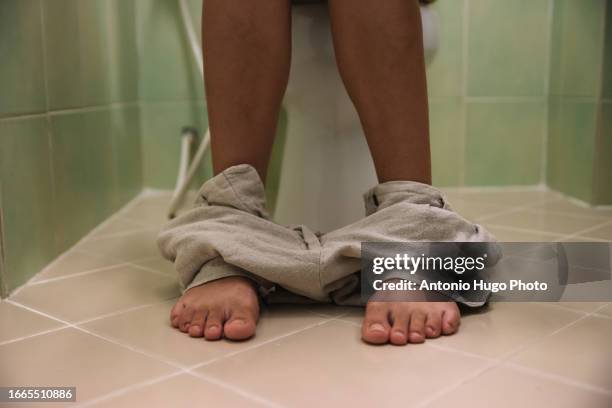 close-up of a woman sitting on the toilet - woman hemorrhoids 個照片及圖片檔