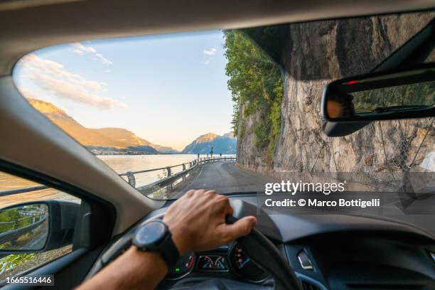 personal perspective of person driving along lake como, italy - car point of view stock pictures, royalty-free photos & images