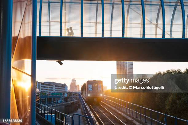 dlr train in east london at sunset, uk - docklands light railway stock pictures, royalty-free photos & images