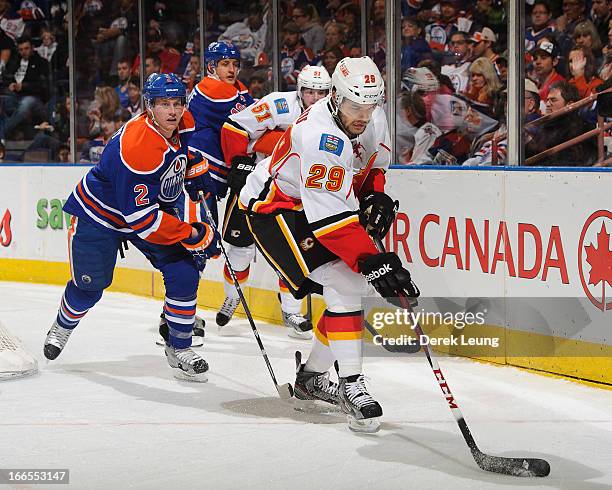 Akim Aliu of the Calgary Flames skates with the puck against the Edmonton Oilers during an NHL game at Rexall Place on April 13, 2013 in Edmonton,...