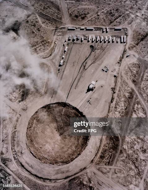 Aerial view of the subsidence crater that was formed by the Huron King underground nuclear test, with the Huron King test chamber also visible ,...