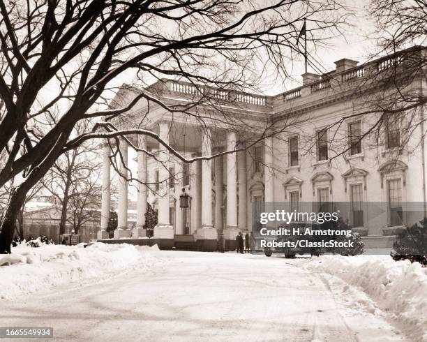 1930s North facing facade of the white house surrounded by winter snow washington dc USA.