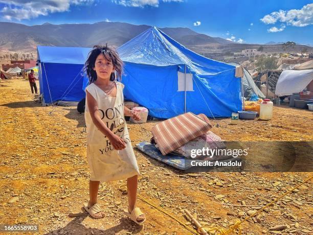 Girl is seen near the tents as search and rescue operations continue for people trapped under rubble after 7 magnitude earthquake in the Amizmiz town...
