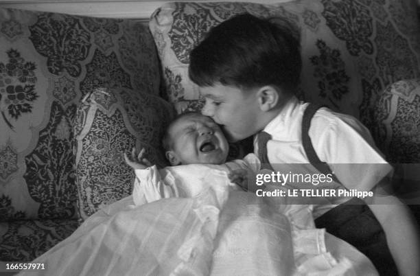 Danet-Nouel Baptism. Baptême de l'enfant d'un employé de Paris-Match nommé DANET-NOUEL : la cérémonie à l'église, les invités : le nourrisson allongé...