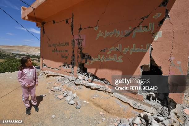 Girl looks at a heavily damaged school in the earthquake-hit village of Ardouz, in Morocco's Amizmiz region on September 14, 2023. Rescue teams...