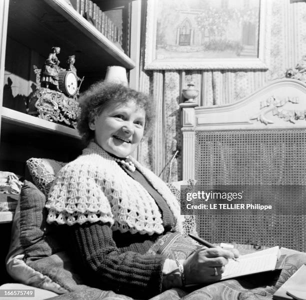 Rendezvous With Angelina Bardin. Sarthe- 24 Novembre 1956- Chez elle, Angelina BARDIN, romancière de la campagne sarthoise, assise sur un lit,...