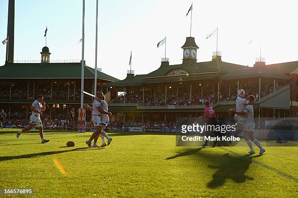 The Dragons celebrate after Matt Cooper of the Dragons scored a try during the round six NRL match between the Wests Tigers and the St George...