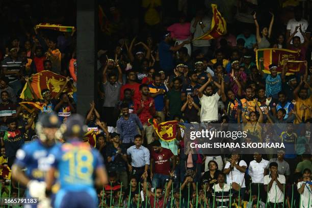 Sri Lanka's fans wave national flags during the Asia Cup 2023 Super Four one-day international cricket match between Sri Lanka and Pakistan at the R....