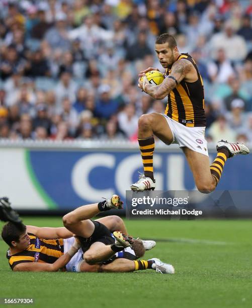 Lance Franklin of the Hawks jumps over players with the ball during the round three AFL match between the Collingwood Magpies and the Hawthorn Hawks...