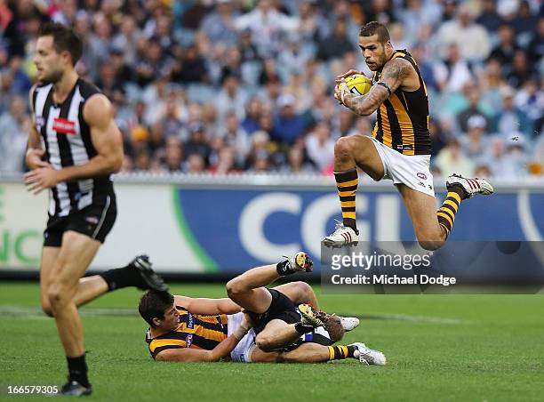 Lance Franklin of the Hawks jumps over players with the ball during the round three AFL match between the Collingwood Magpies and the Hawthorn Hawks...