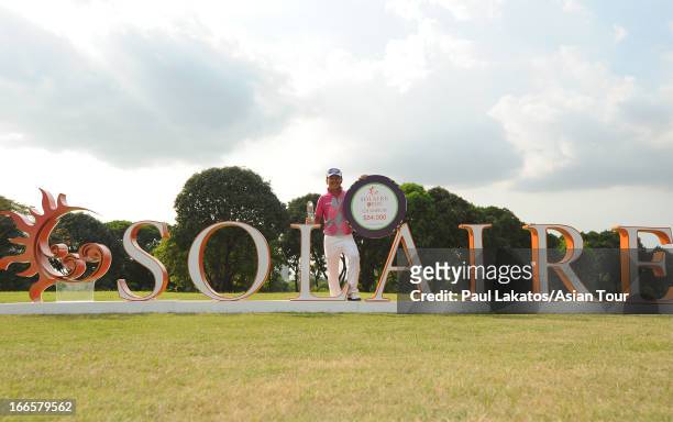 Lin Wen-tang of Chinese Taipei poses with the winner's trophy during day four of the Solaire Open at Wack Wack Golf and Country Club on April 14,...