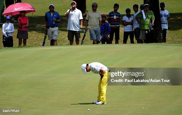 Miguel Tabuena of the Phlippines reacts to a missed putt during day four of the Solaire Open at Wack Wack Golf and Country Club on April 14, 2013 in...