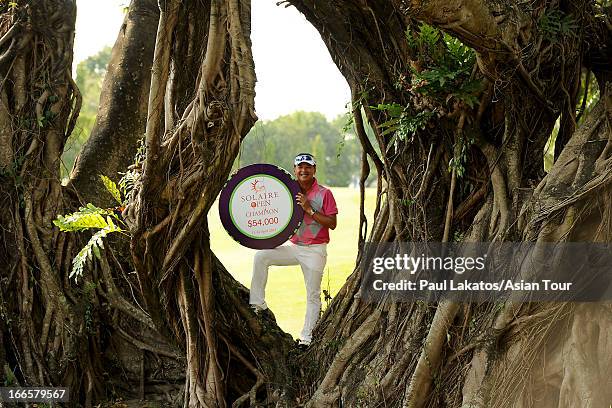 Lin Wen-tang of Chinese Taipei poses with the winner's trophy during day four of the Solaire Open at Wack Wack Golf and Country Club on April 14,...