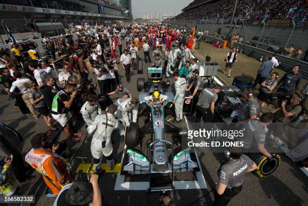 Mercedes driver Lewis Hamilton of Britain exits his car after parking on the starting grid of the Formula One Chinese Grand Prix in Shanghai on April...