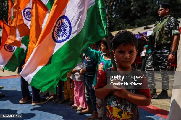 Kashmiri Children wave Indian National Flag during Central Reserve Police Force Free Medical Camp In Baramulla Jammu and Kashmir India on 14...