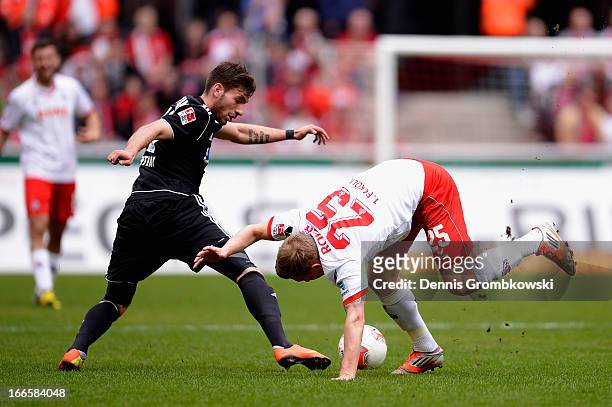 Enrico Valentini of VfR Aalen challenges Daniel Royer of 1. FC Koeln during the Second Bundesliga match between 1. FC Koeln and VfR Aalen at...