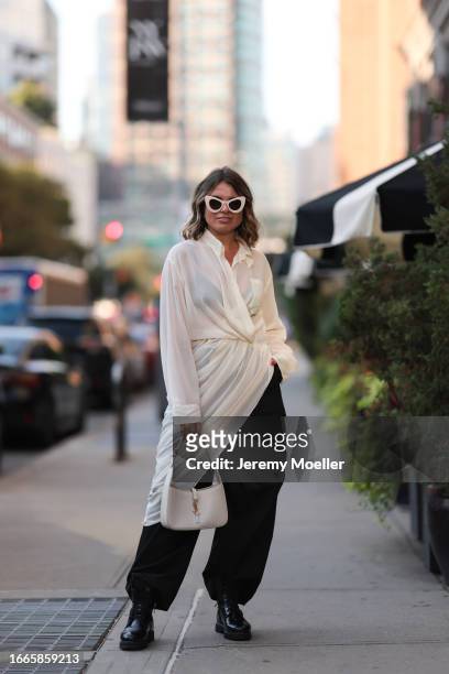 Natalia Levsina seen wearing white modern shaped sunglasses, gold jewelry, JNBY Official white sheer / transparent asymmetrical long blouse shirt,...