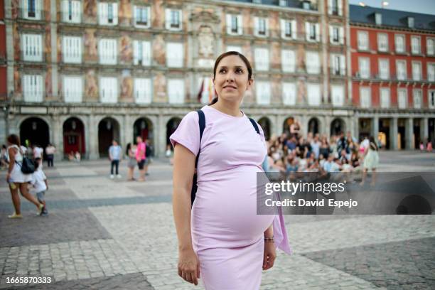 pregnant woman in plaza mayor in madrid, spain. - abdomen quadrants stock pictures, royalty-free photos & images