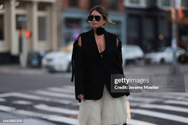 Natalia Levsina seen wearing black rhinestone pattern sunglasses, black flower necklace, JNBY Official black blazer jacket with cut-outs and straps,...