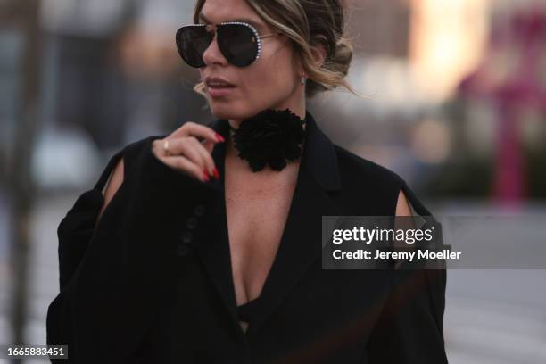 Natalia Levsina seen wearing black rhinestones pattern sunglasses, black flower necklace, JNBY Official black blazer jacket with cut-outs and straps,...