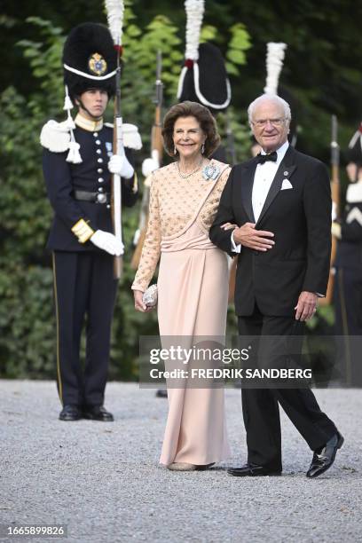 Sweden's Queen Silvia and King Carl XVI Gustaf arrive at Drottningholm Palace Theatre in Stockholm, September 14 for the Royal Opera's jubilee...