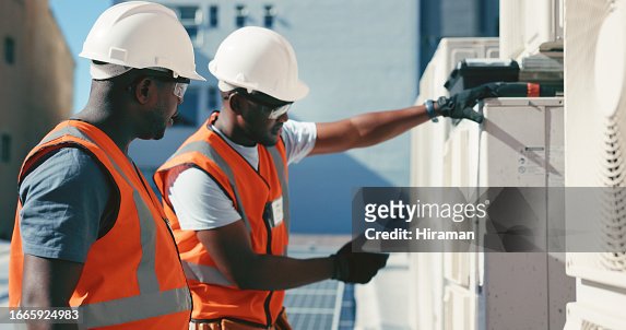 Construction worker, collaboration to install an air conditioner on the roof of a building for ventilation. Teamwork, maintenance or service with an engineer and electrician working on ac repair