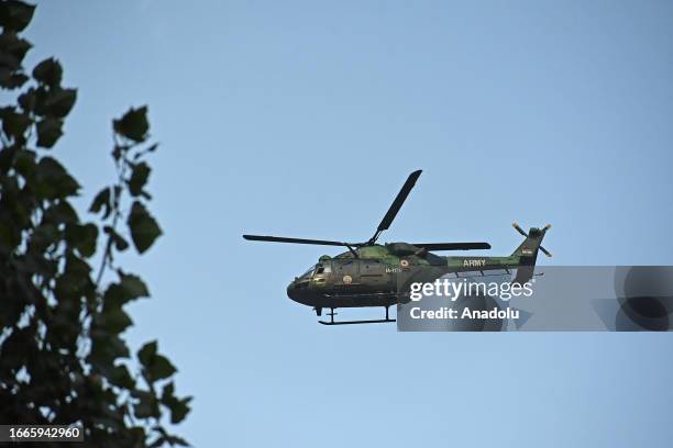 An Indian army helicopter hovers during the gun-battle between militants and security forces which entered second day in Gadole village of Kokernag...