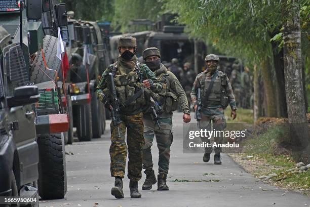 Indian army soldiers are seen near the gun-battle site which entered second day in Gadole village of Kokernag in Anantnag district of...