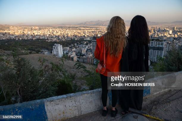 Tehran, Iran. Two young Iranian girls, not wearing the mandatory hijab, visit 'Bame-Tehran.'