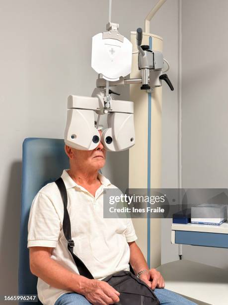 senior man visiting ophthalmologist - optical equipment stock pictures, royalty-free photos & images