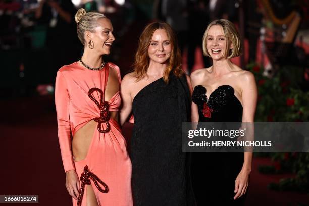 British model Poppy Delevingne, British fashion designer Stella McCartney and British actress Carey Mulligan pose upon arrival to attend the "Vogue...