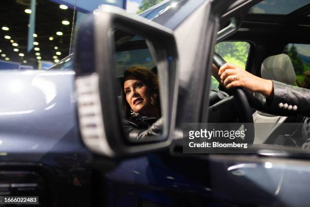 Gretchen Whitmer, governor of Michigan, sits inside a 2024 Ford F-150 Lightning electric truck during the 2023 North American International Auto Show...