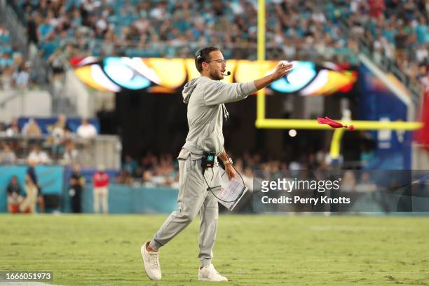 Mike McDaniel of the Miami Dolphins throws a red challenge flag against the Jacksonville Jaguars during the first half at EverBank Stadium on...