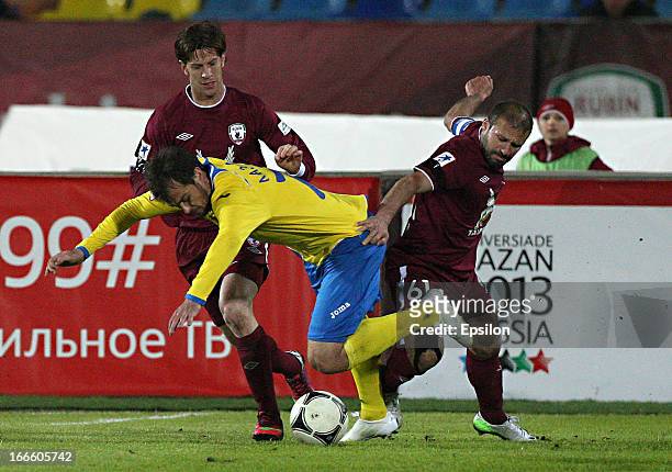 Gokdeniz Karadeniz of FC Rubin Kazan is challenged by Danko Lazovic of FC Rostov Rostov-on-Don during the Russian Football League Championship match...
